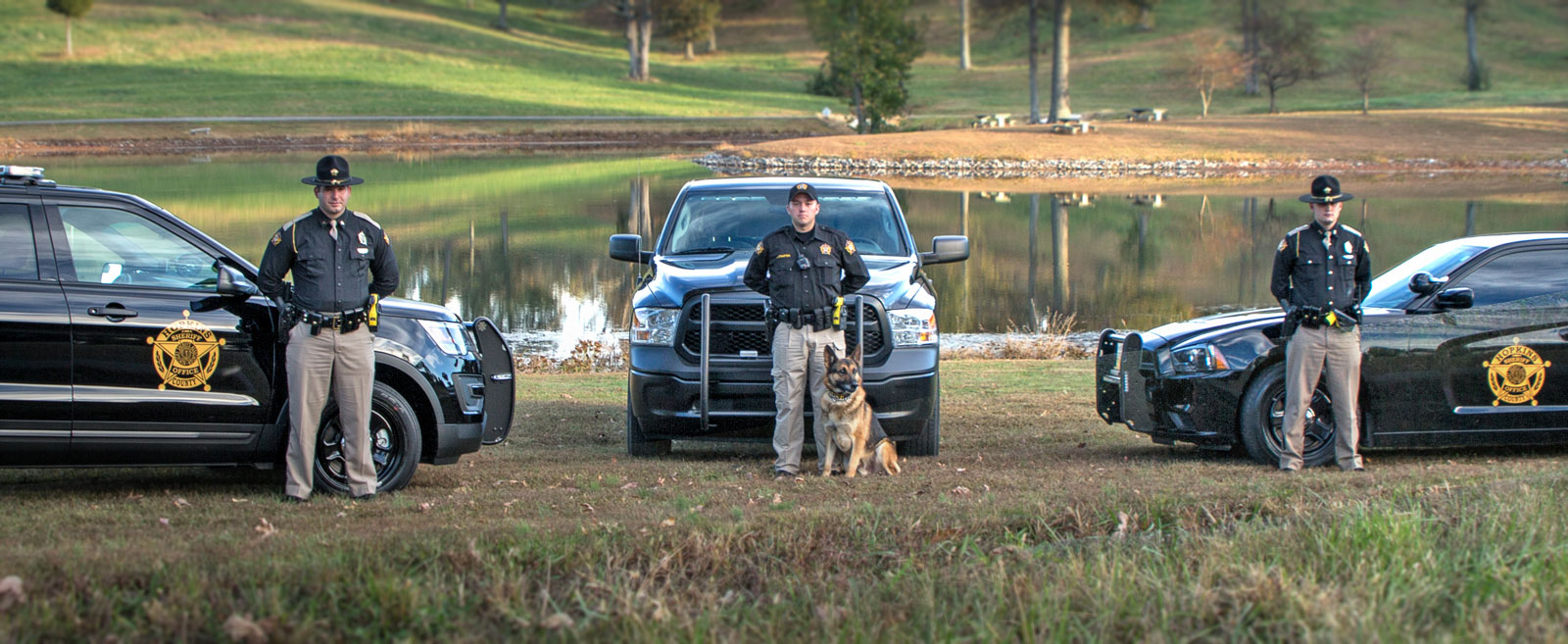 Photo with Vehicles, officers, and a k9